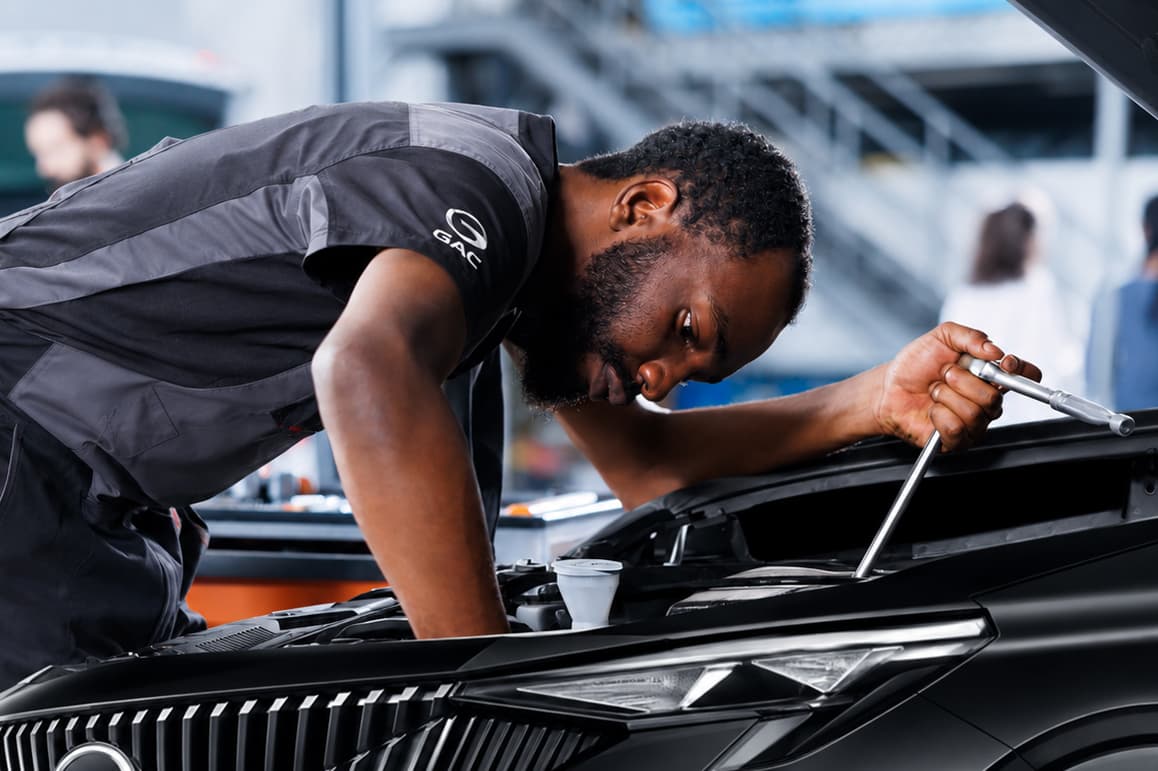 Technician reviewing a vehicle interior with a clipboard